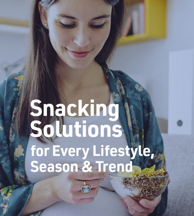 Snacking Solutions for Every Lifetyle, Season and Trend. Woman eating snack blend.